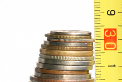 Stack of coins and ruler, indicating reduced costs