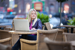 Woman in cafe using cloud computing 