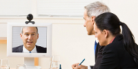 People using videoconferencing equipment