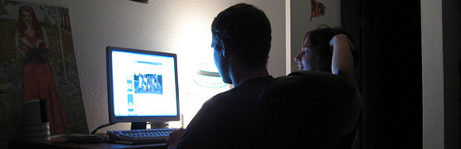 Two hackers sitting at a computer